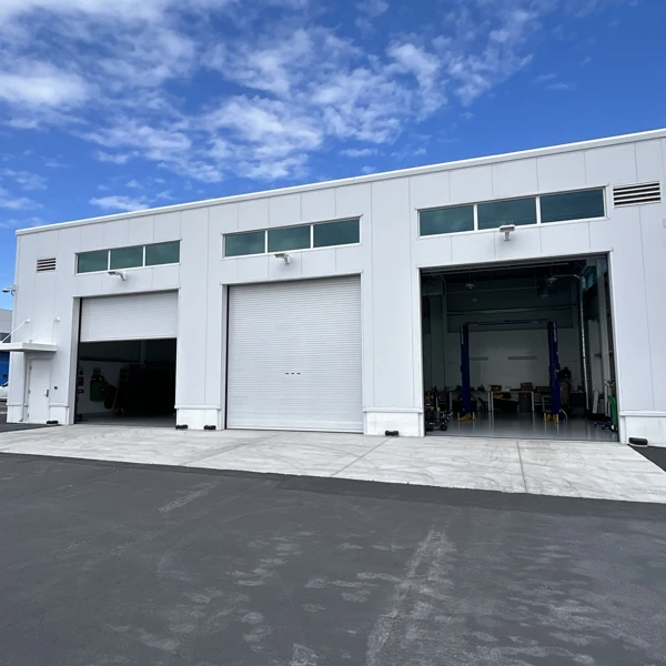 Commercial steel auto repair building with multiple vehicle service bay doors